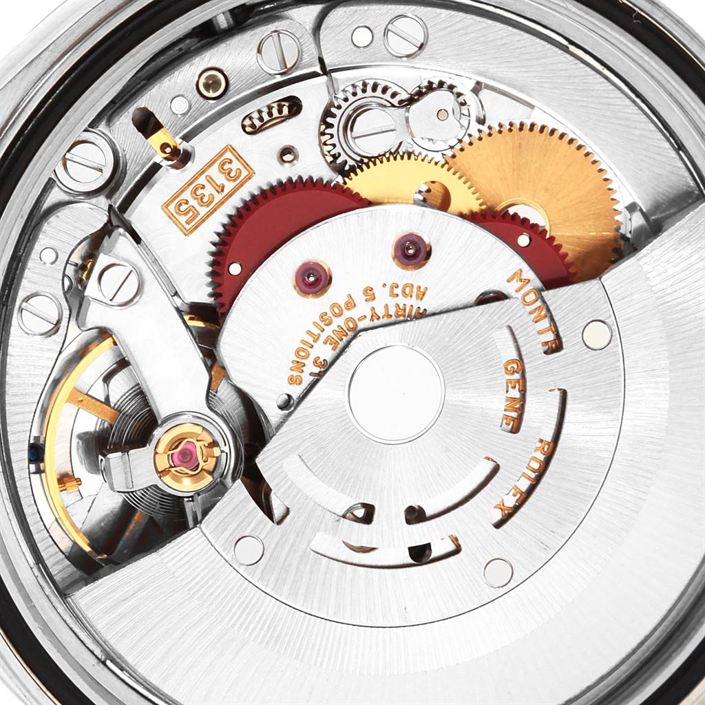 This close-up angle of the Rolex Datejust 16203 Men's Steel and Gold (two tone) Grey Dial 16203 Men's Steel and Gold (two tone) Grey Dial model shows the intricate internal mechanical components and gears.