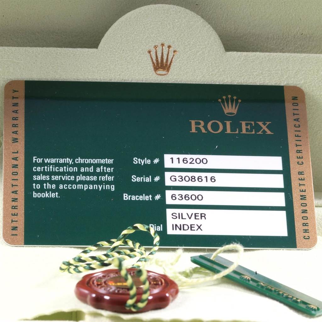 This image shows the warranty card and accessories for a Rolex Datejust 116200 Men's Stainless Steel Silver Dial 116200 Men's Stainless Steel Silver Dial model, including serial and style numbers, with a string tag.