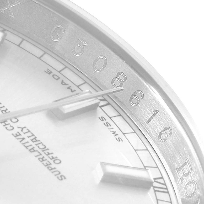 This is a close-up of the Rolex Datejust 116200 Men's Stainless Steel Silver Dial 116200 Men's Stainless Steel Silver Dial watch, showing the dial, hands, and part of the inner bezel with engraved numbers.