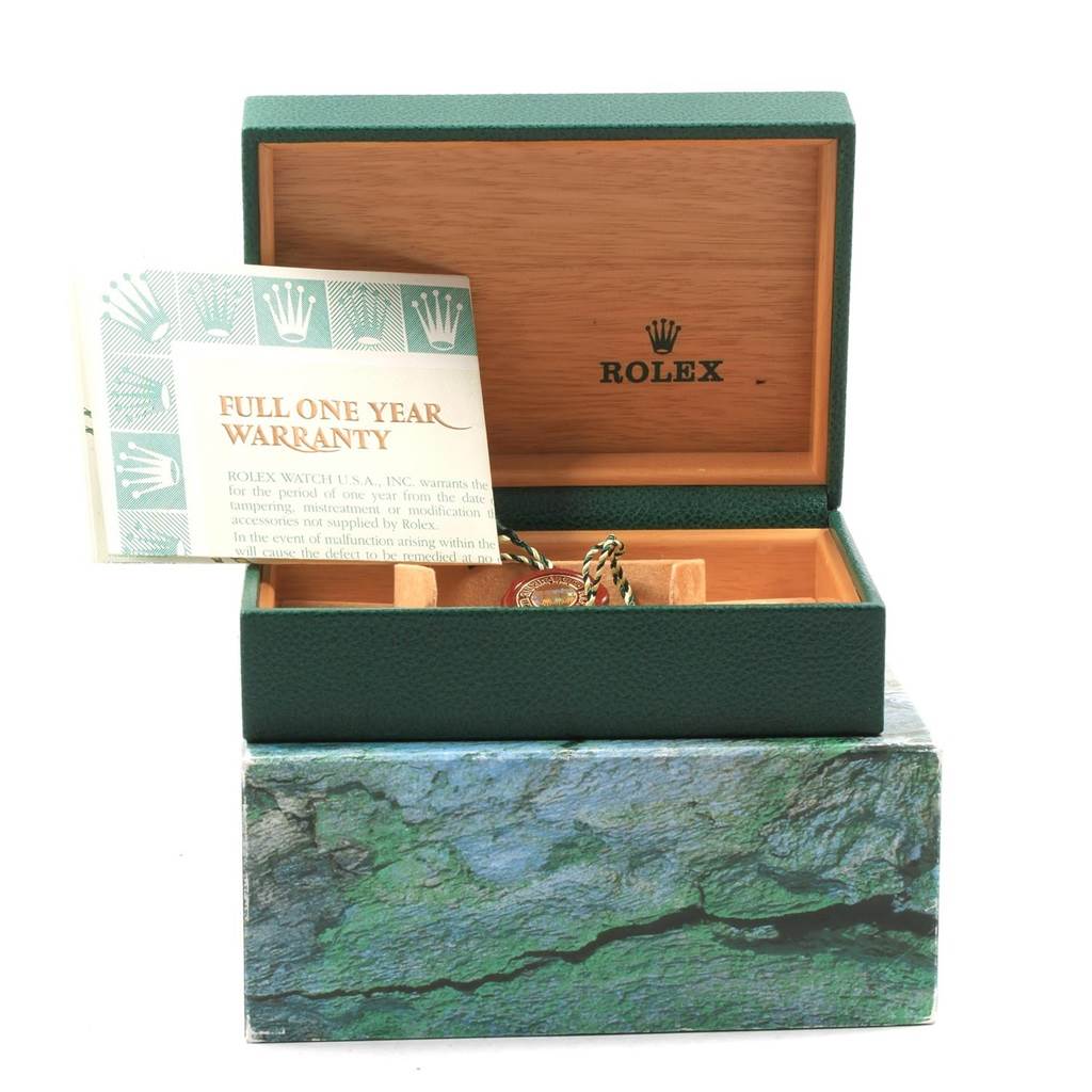 The image shows an open green Rolex box with a warranty card visible and some accessories inside for the Rolex Datejust 20208 Men
s Steel and Gold (two tone) Grey Dial 20208 Men
s Steel and Gold (two tone) Grey Dial model.