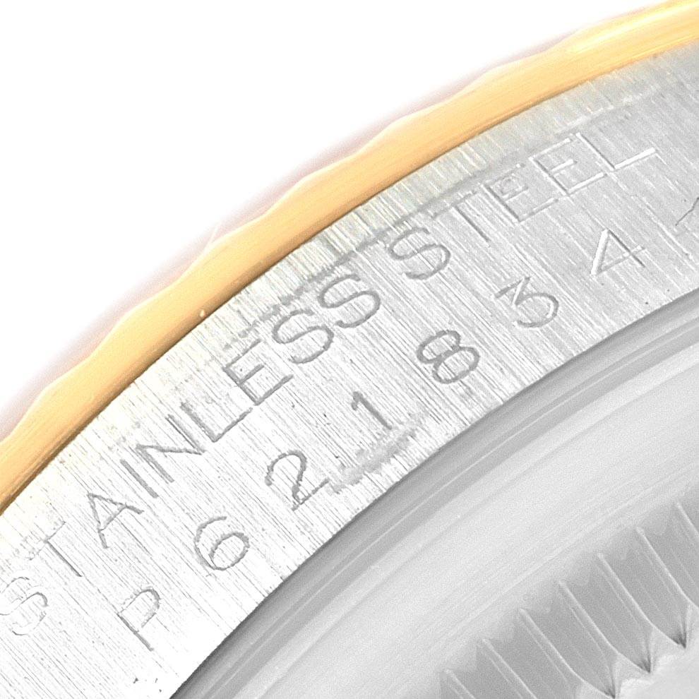 The image shows a close-up of the side engraving on the bezel of a Rolex Datejust 20208 Men
s Steel and Gold (two tone) Grey Dial 20208 Men
s Steel and Gold (two tone) Grey Dial watch, emphasizing the stainless steel marking.
