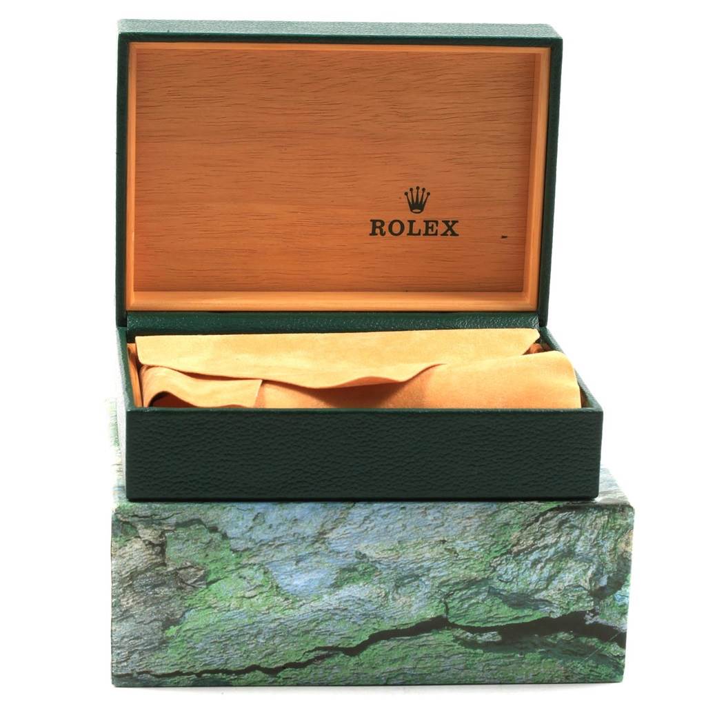 The image shows an open Rolex Datejust 16233 Men
s Steel and Gold (two tone) White Dial 16233 Men
s Steel and Gold (two tone) White Dial watch box with a green exterior, wooden interior, and a protective cloth inside.