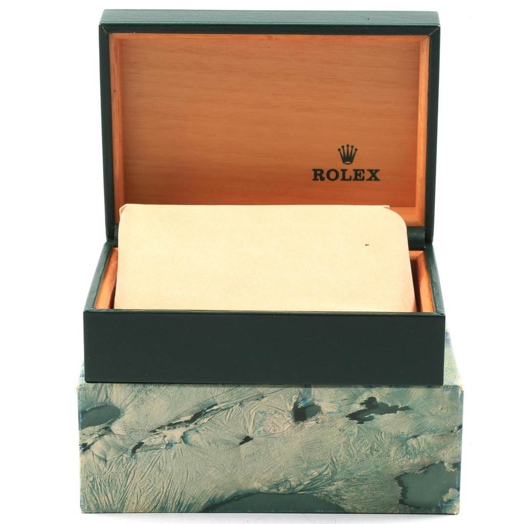 The image shows an open green and wood Rolex box, presumably for the Datejust model, with no watch visible inside.