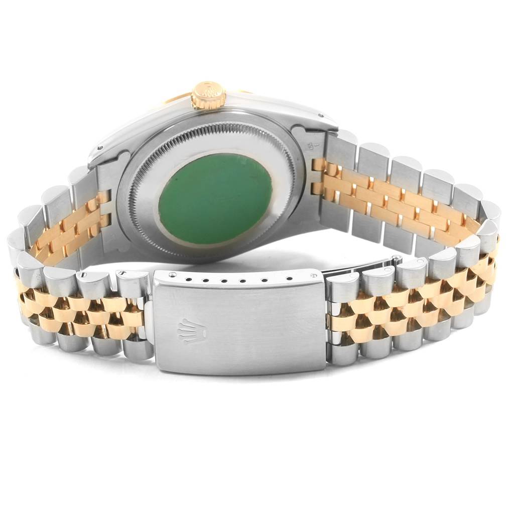 This image shows the back view of a Rolex Datejust 16233 Men
s Steel and Gold (two tone) Champagne Dial 16233 Men
s Steel and Gold (two tone) Champagne Dial watch, highlighting its case, crown, and two-tone metal bracelet with a clasp.