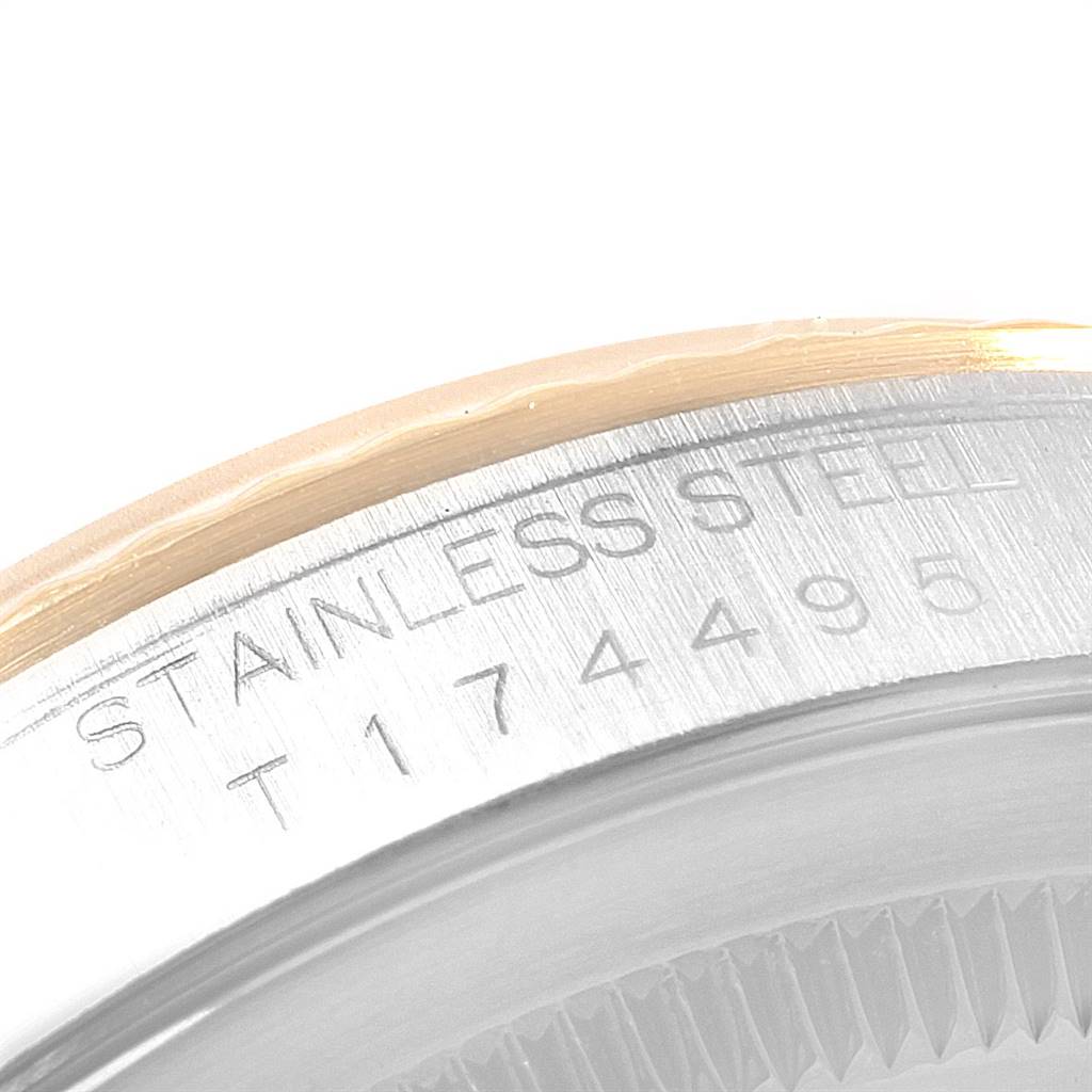 The image shows a close-up angled view of the bezel and part of the case back of a Rolex Datejust 16233 Men
s Steel and Gold (two tone) Beige Dial 16233 Men
s Steel and Gold (two tone) Beige Dial watch.