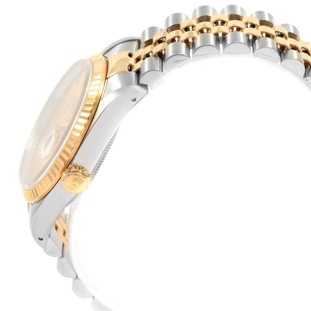 This image shows a side view of the Rolex Datejust 16233 Men
s Steel and Gold (two tone) Champagne Dial 16233 Men
s Steel and Gold (two tone) Champagne Dial watch, highlighting its crown, bezel, and part of the Jubilee bracelet.