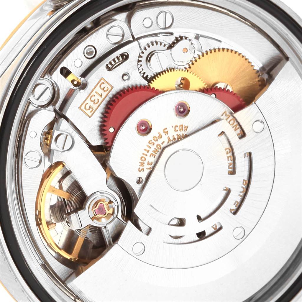 The image shows a close-up of the movement mechanism inside a Rolex Datejust 16233 Men
s Steel and Gold (two tone) Champagne Dial 16233 Men
s Steel and Gold (two tone) Champagne Dial watch, highlighting gears and components.