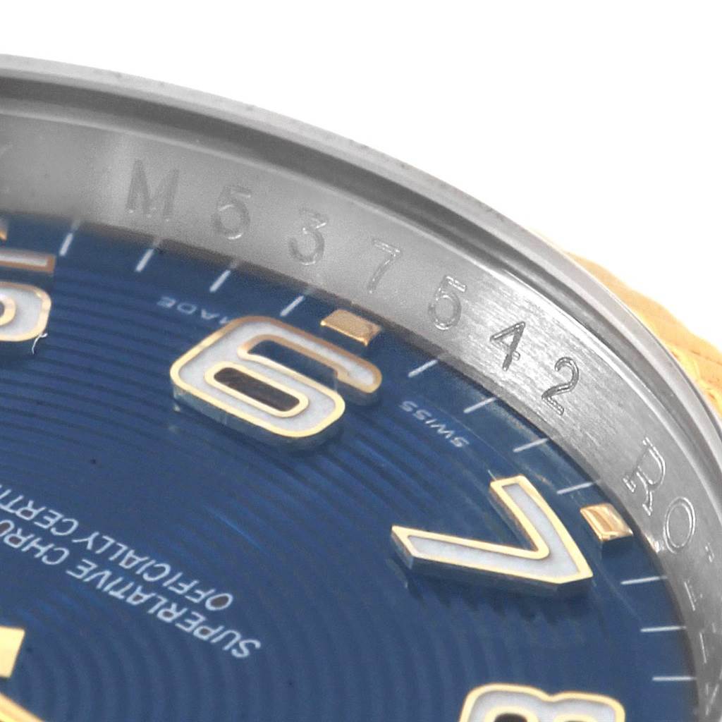 This close-up image of a Rolex Datejust 116233 Men
s Stainless Steel Blue Dial 116233 Men
s Stainless Steel Blue Dial shows the bezel edge and part of the blue watch face with numerals.