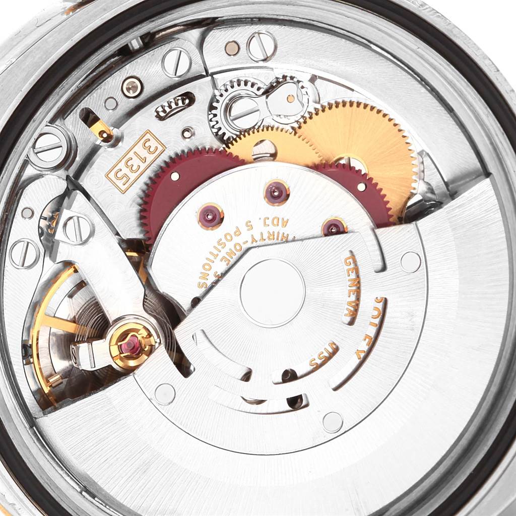 This image shows a close-up of the Rolex Datejust 116233 Men's Stainless Steel Champagne Dial 116233 Men's Stainless Steel Champagne Dial watch's movement, including the gears and rotor.