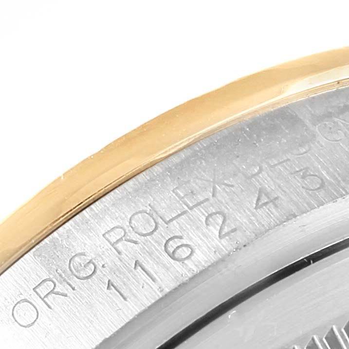 The image shows a close-up angle of the bezel and engraved inner ring of a Rolex Datejust 116243 Men's Stainless Steel Champagne Dial 116243 Men's Stainless Steel Champagne Dial watch.