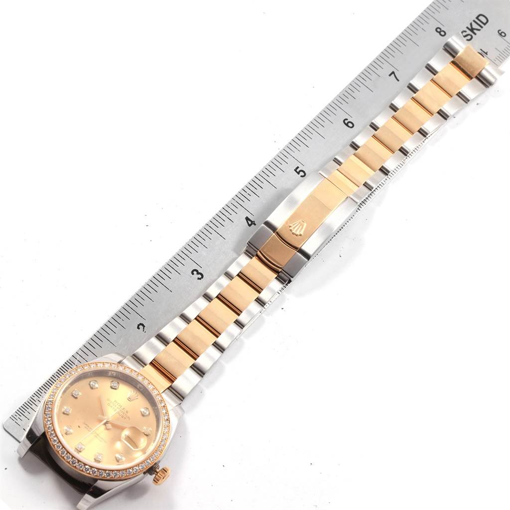 The image shows a top-down view of a Rolex Datejust 116243 Men's Stainless Steel Champagne Dial 116243 Men's Stainless Steel Champagne Dial watch, displaying the face, bezel, and bracelet, with parts measured against a ruler.