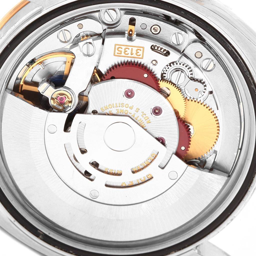 This image shows the internal mechanism of a Rolex Datejust 116243 Men's Stainless Steel Champagne Dial 116243 Men's Stainless Steel Champagne Dial watch, highlighting the rotor, gears, and movement components.