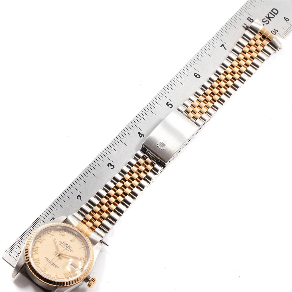 The image shows the Rolex Datejust 16233 Men
s Steel and Gold (two tone) Beige Dial 16233 Men
s Steel and Gold (two tone) Beige Dial model watch laid flat against a ruler, displaying the face, bracelet, and clasp.