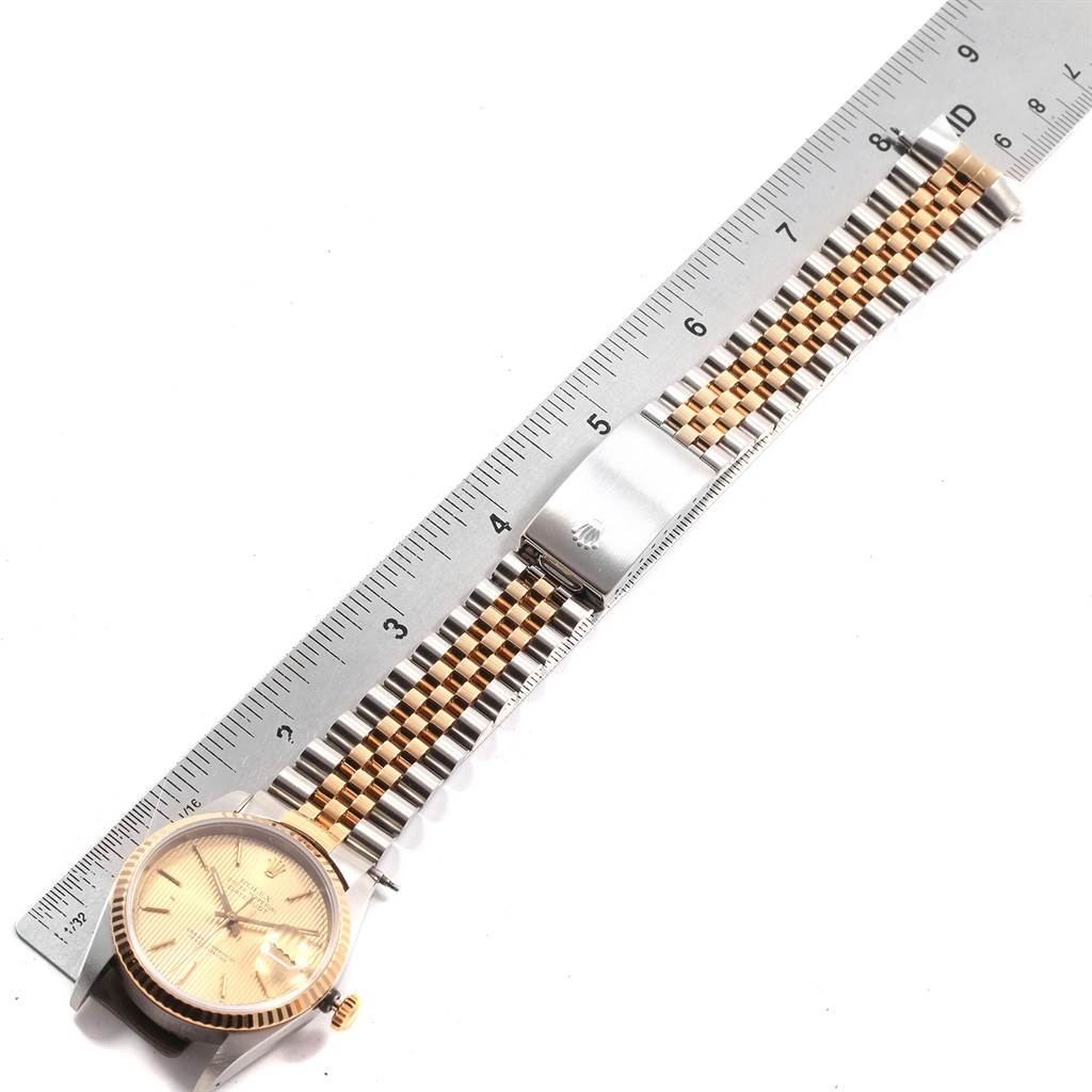 The image shows a Rolex Datejust 16233 Men's Steel and Gold (two tone) Champagne Dial 16233 Men's Steel and Gold (two tone) Champagne Dial watch laid flat with a ruler measuring its two-tone bracelet.