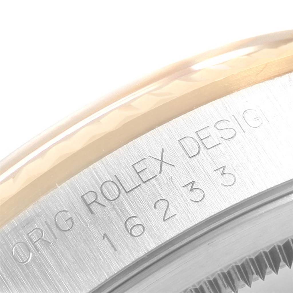 This is a close-up angle of the case side of a Rolex Datejust 16233 Men's Steel and Gold (two tone) Champagne Dial 16233 Men's Steel and Gold (two tone) Champagne Dial, showing the model number engraving.