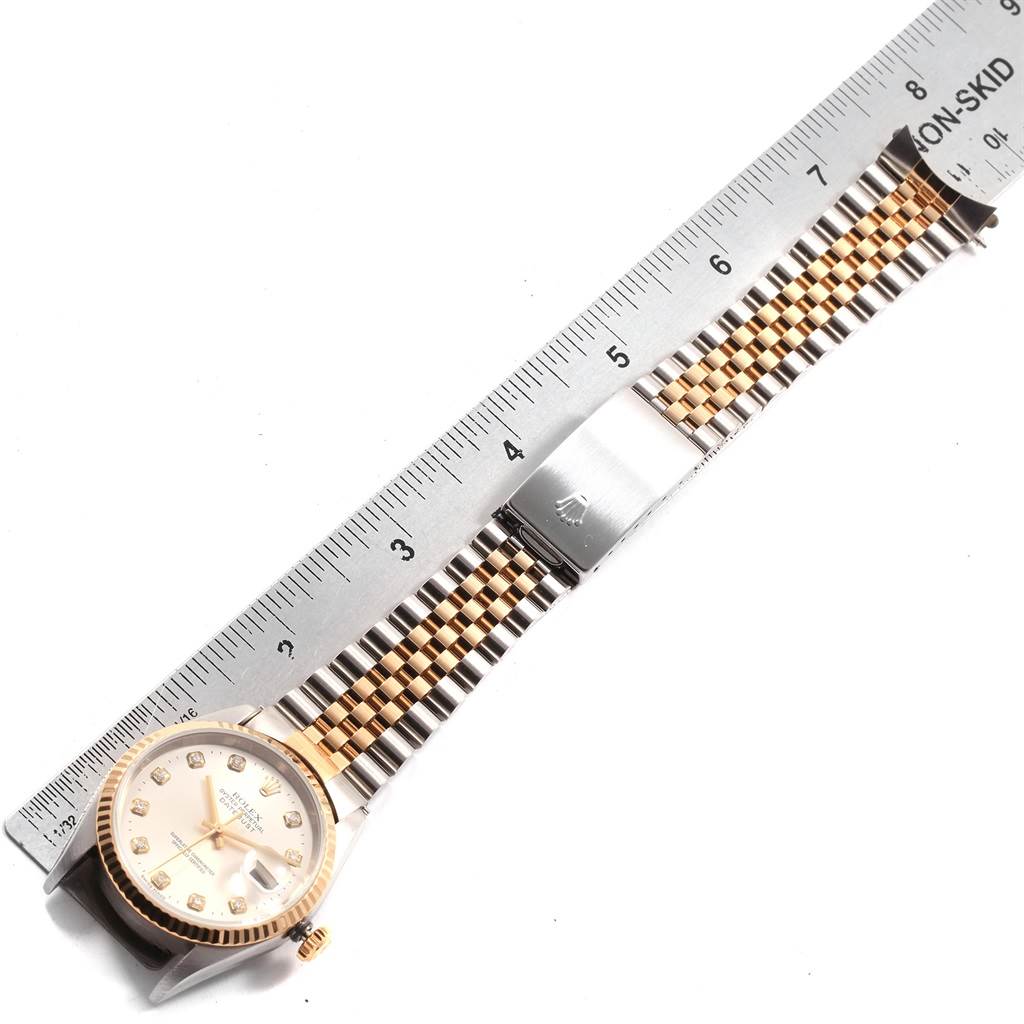 The image shows a Rolex Datejust 16233 Men's Steel and Gold (two tone) Silver Dial 16233 Men's Steel and Gold (two tone) Silver Dial watch laid flat, measured against a ruler displaying its face, bezel, and Jubilee bracelet.