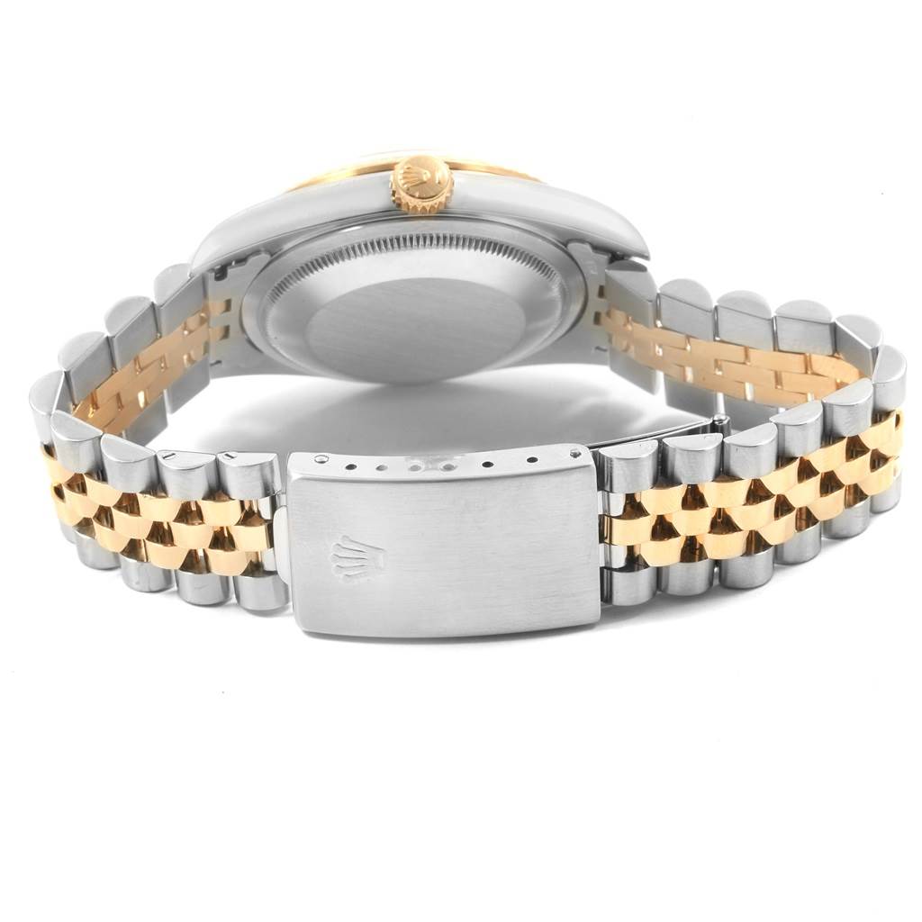 The image shows the back and clasp of a Rolex Datejust 16233 Men's Steel and Gold (two tone) Silver Dial 16233 Men's Steel and Gold (two tone) Silver Dial watch, highlighting its two-tone metal bracelet and case.