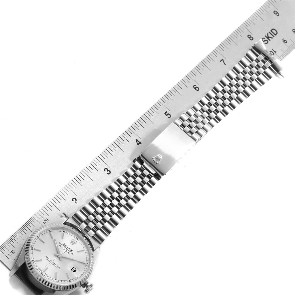 This image shows a top-down view of a Rolex Datejust 16234 Men's Stainless Steel Silver Dial 16234 Men's Stainless Steel Silver Dial watch, focusing on the face, bracelet, and clasp, with a ruler for scale.