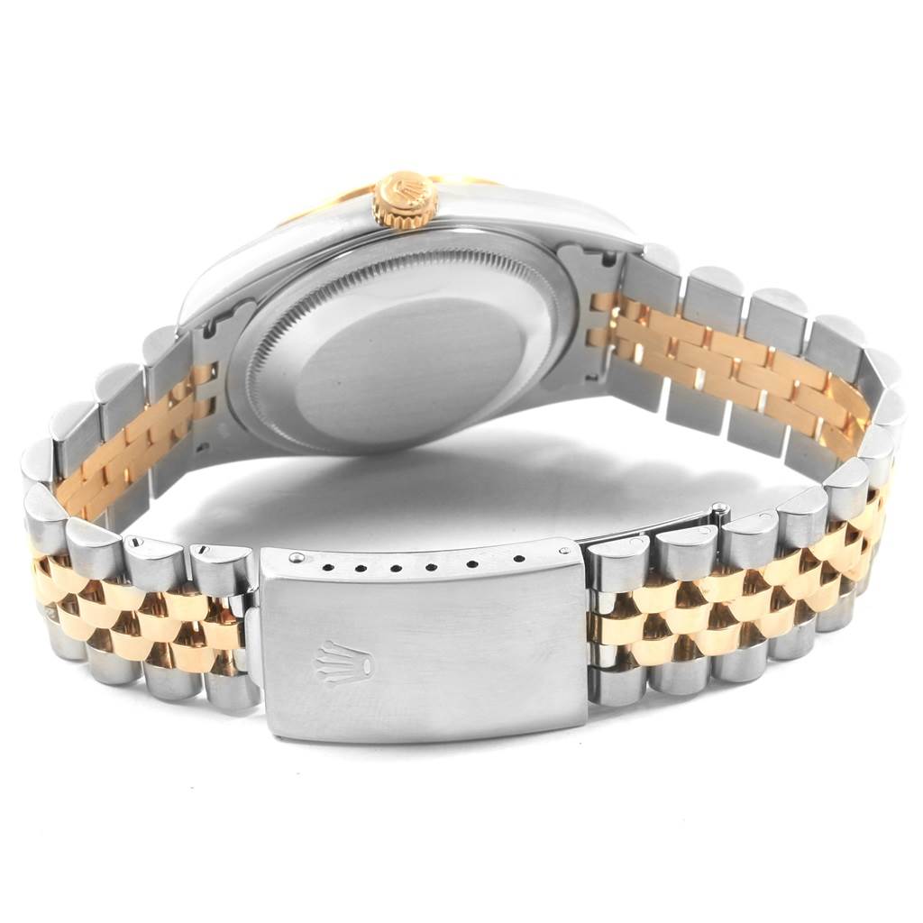 The image shows the back of a Rolex Datejust 16233 Men
s Steel and Gold (two tone) Black Dial 16233 Men
s Steel and Gold (two tone) Black Dial watch with its case back and partially open clasp.