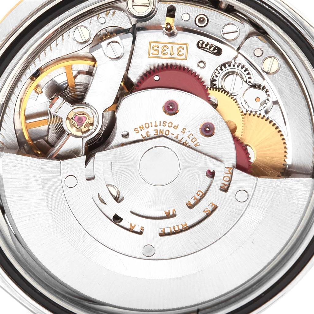 The image shows the intricate movement and mechanical components of a Rolex Datejust 16233 Men
s Steel and Gold (two tone) Black Dial 16233 Men
s Steel and Gold (two tone) Black Dial watch from a close-up angle.