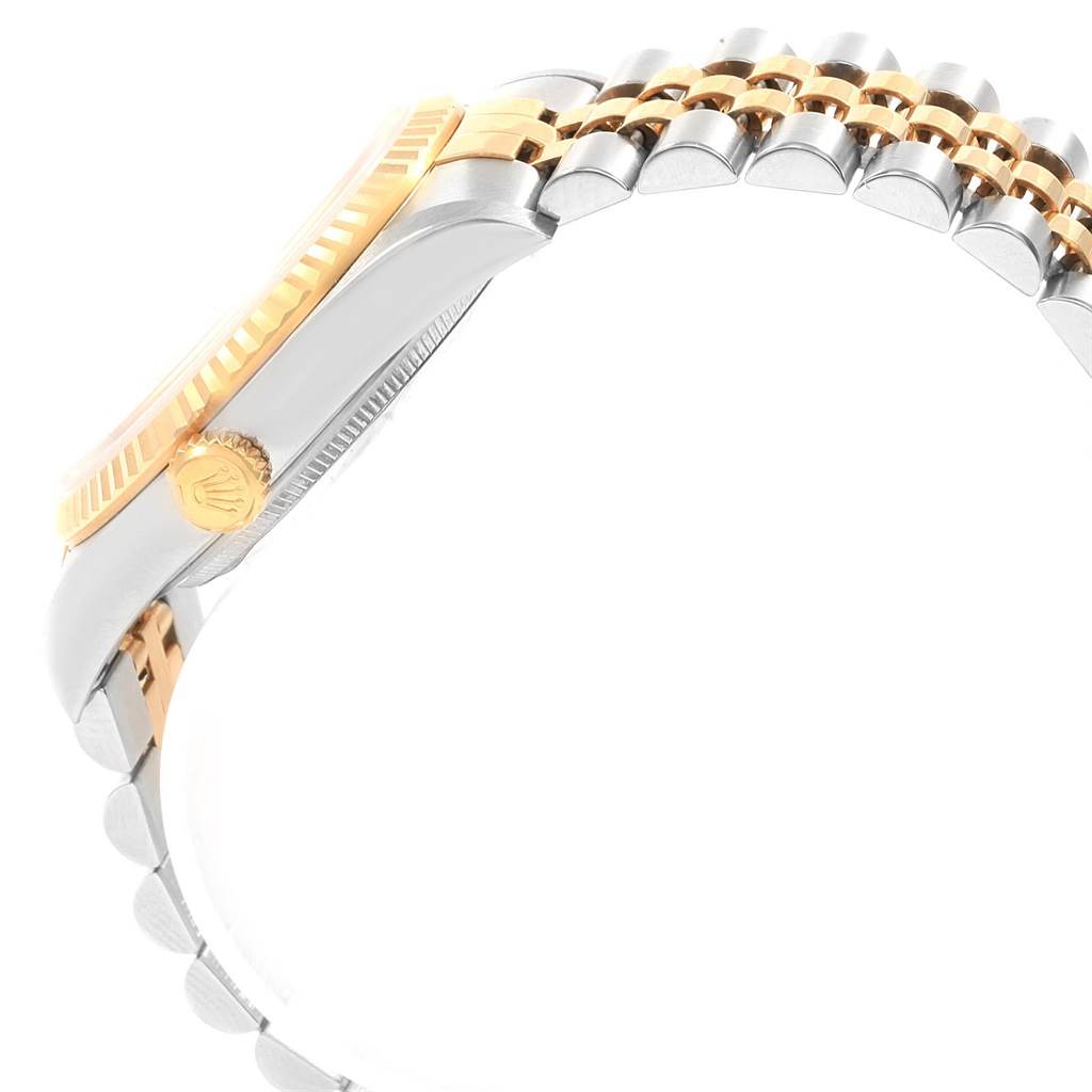 This image shows a side view of the Rolex Datejust 16233 Men's Steel and Gold (two tone) Silver Dial 16233 Men's Steel and Gold (two tone) Silver Dial watch, focusing on the crown, bezel, and part of the jubilee bracelet.