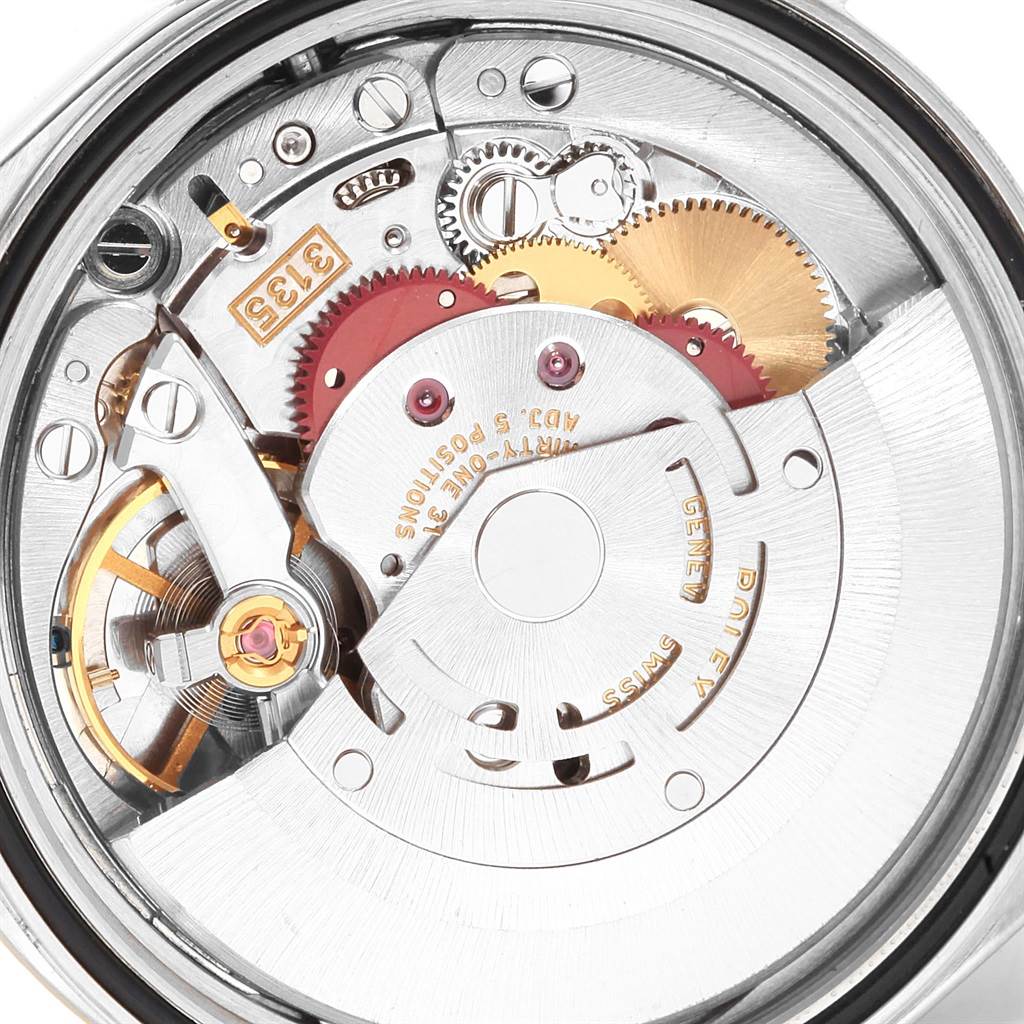 This image shows a close-up view of the internal mechanism of a Rolex Datejust 16233 Men's Steel and Gold (two tone) Silver Dial 16233 Men's Steel and Gold (two tone) Silver Dial watch, highlighting gears and the rotor.