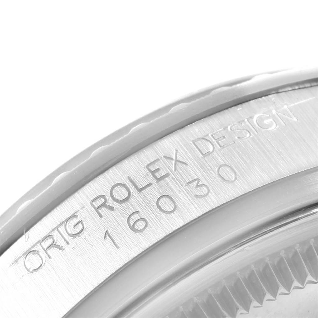 This close-up image shows the engraved case back edge of a Rolex Datejust 16030 Men's Stainless Steel Silver Dial 16030 Men's Stainless Steel Silver Dial watch, detailing its model number.