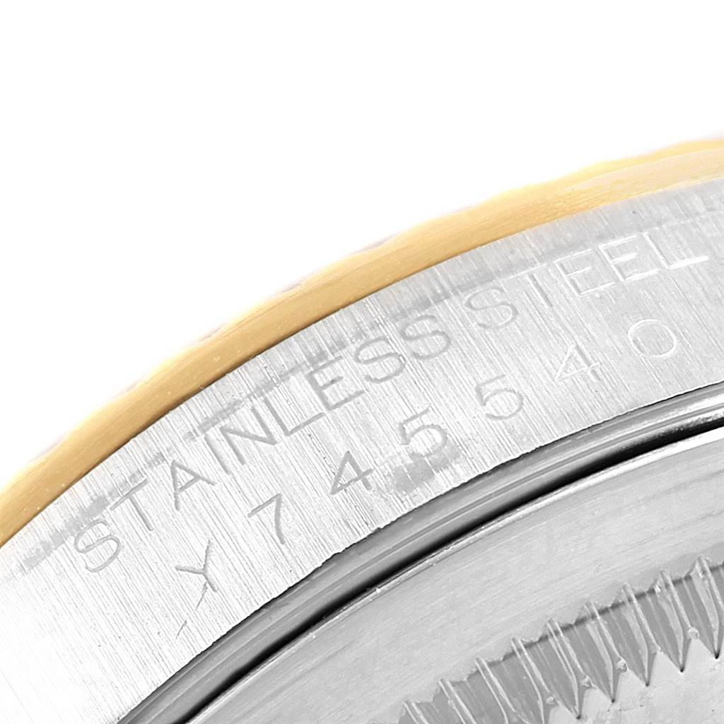 The image shows a close-up of the stainless steel and gold bezel of a Rolex Datejust 16233 Men's Steel and Gold (two tone) White Dial 16233 Men's Steel and Gold (two tone) White Dial watch, highlighting its engraved details.