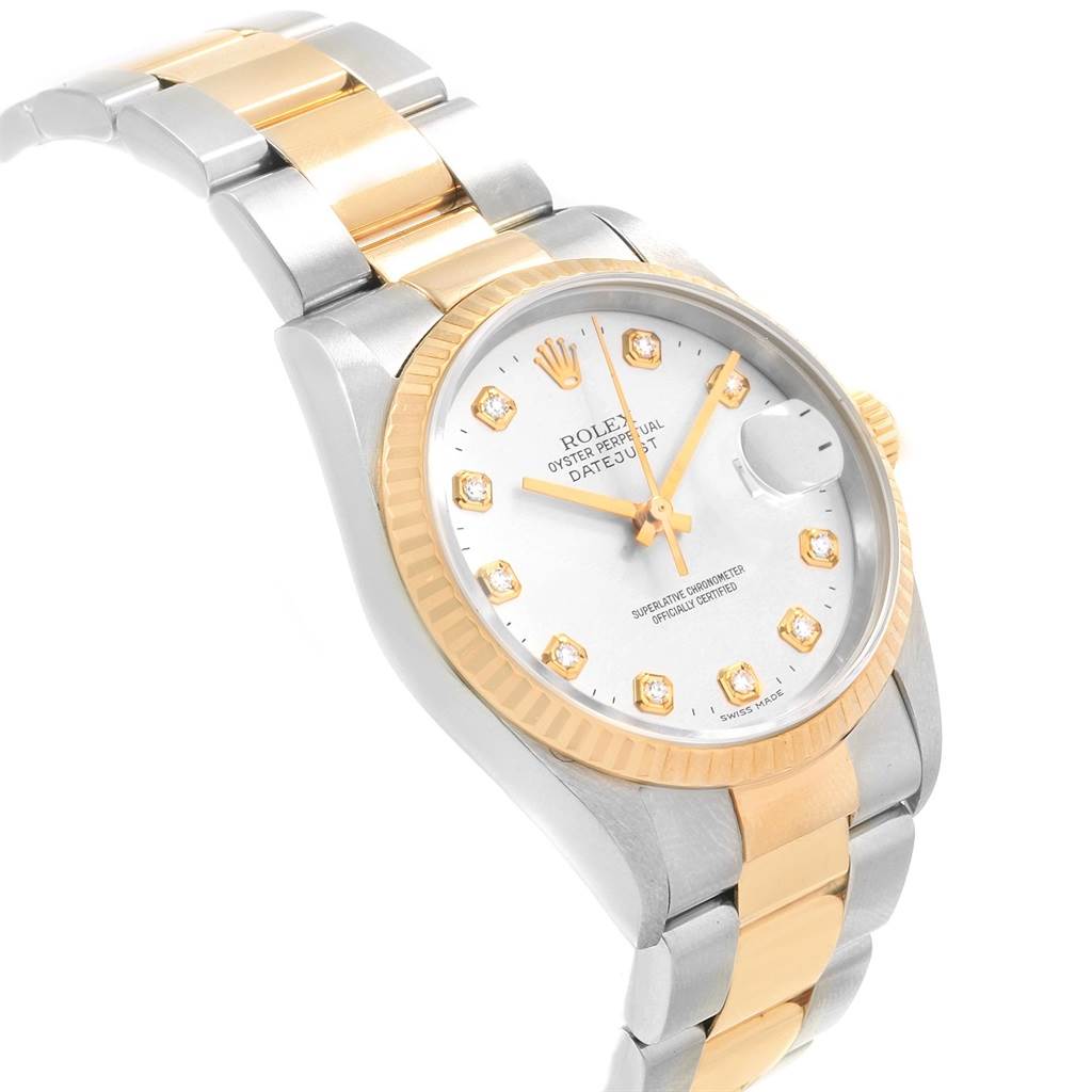 The image shows a Rolex Datejust 16233 Men's Steel and Gold (two tone) White Dial 16233 Men's Steel and Gold (two tone) White Dial watch angled to showcase its dial, fluted bezel, and two-tone bracelet.