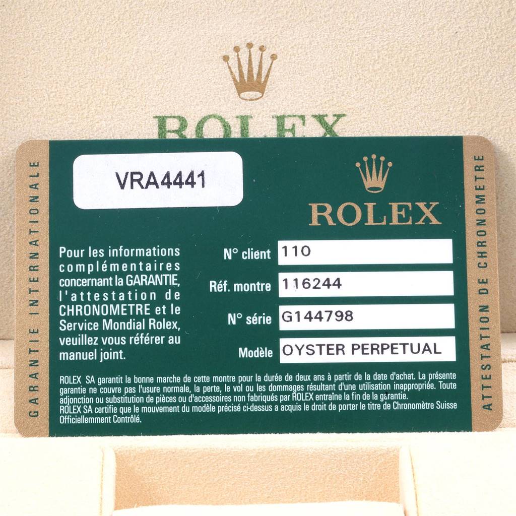 The image shows a warranty card for a Rolex Datejust 116244 Men
s Stainless Steel Silver Dial 116244 Men
s Stainless Steel Silver Dial watch, model Oyster Perpetual, within its packaging.