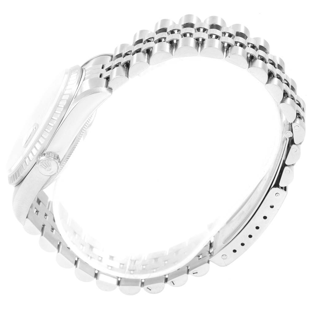 The image shows a side angle of a Rolex Datejust 16220 Men
s Stainless Steel Black Dial 16220 Men
s Stainless Steel Black Dial watch, highlighting the case, the crown, and the bracelet.