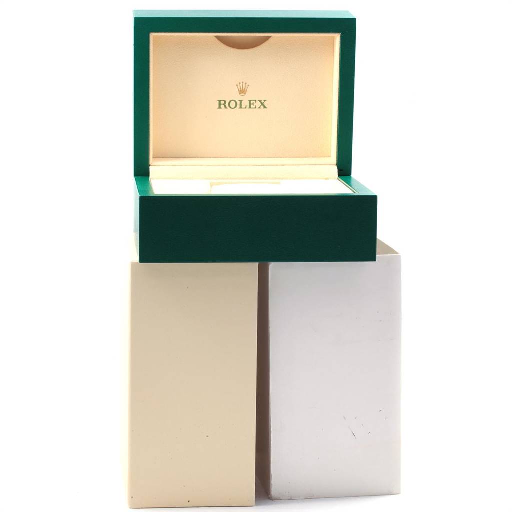 The image shows an open Rolex box for the Datejust model, displaying the green exterior and beige interior with the Rolex logo.