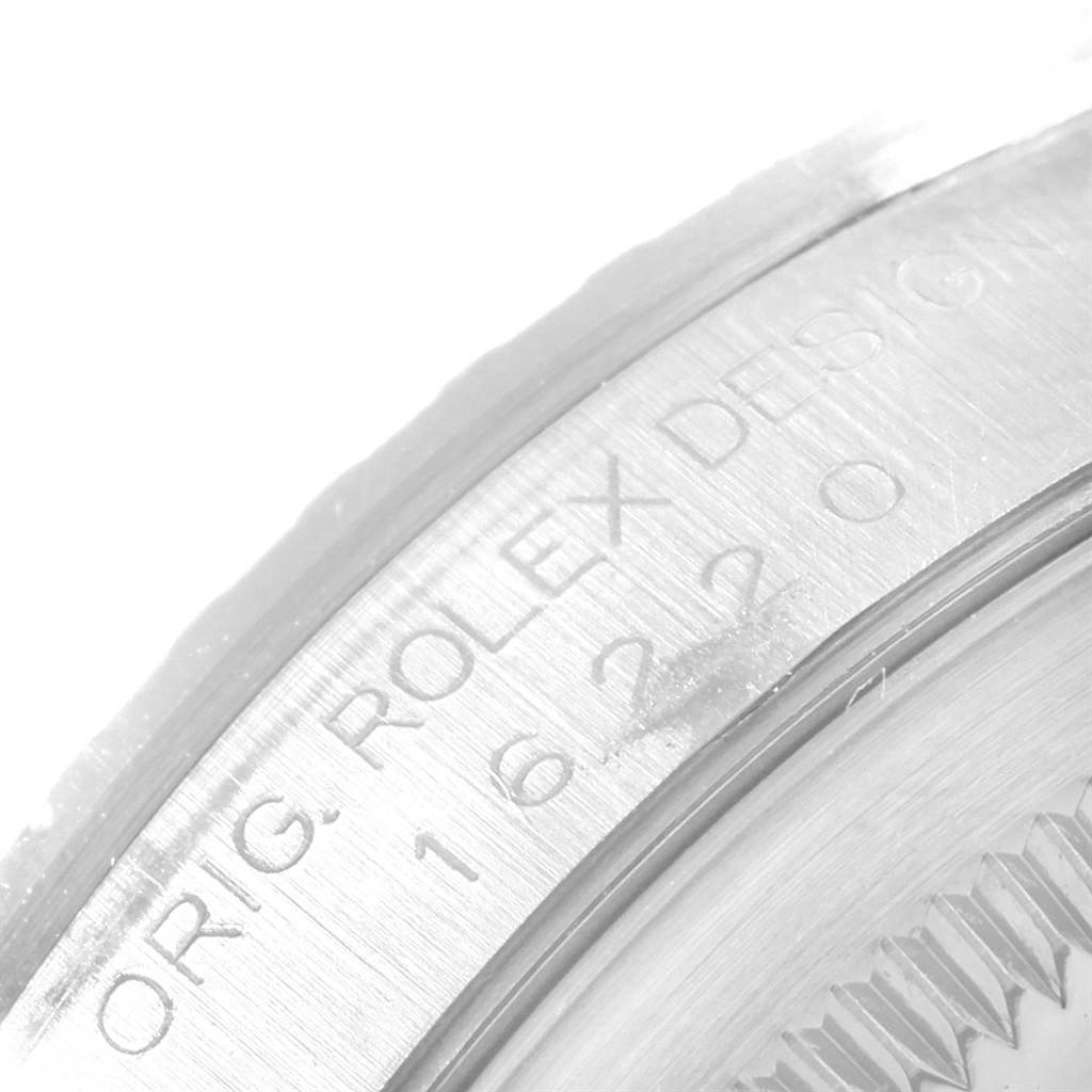 This close-up image shows the side engraving of a Rolex Datejust 16220 Men
s Stainless Steel Blue Dial 16220 Men
s Stainless Steel Blue Dial watch, featuring the model number and branding.