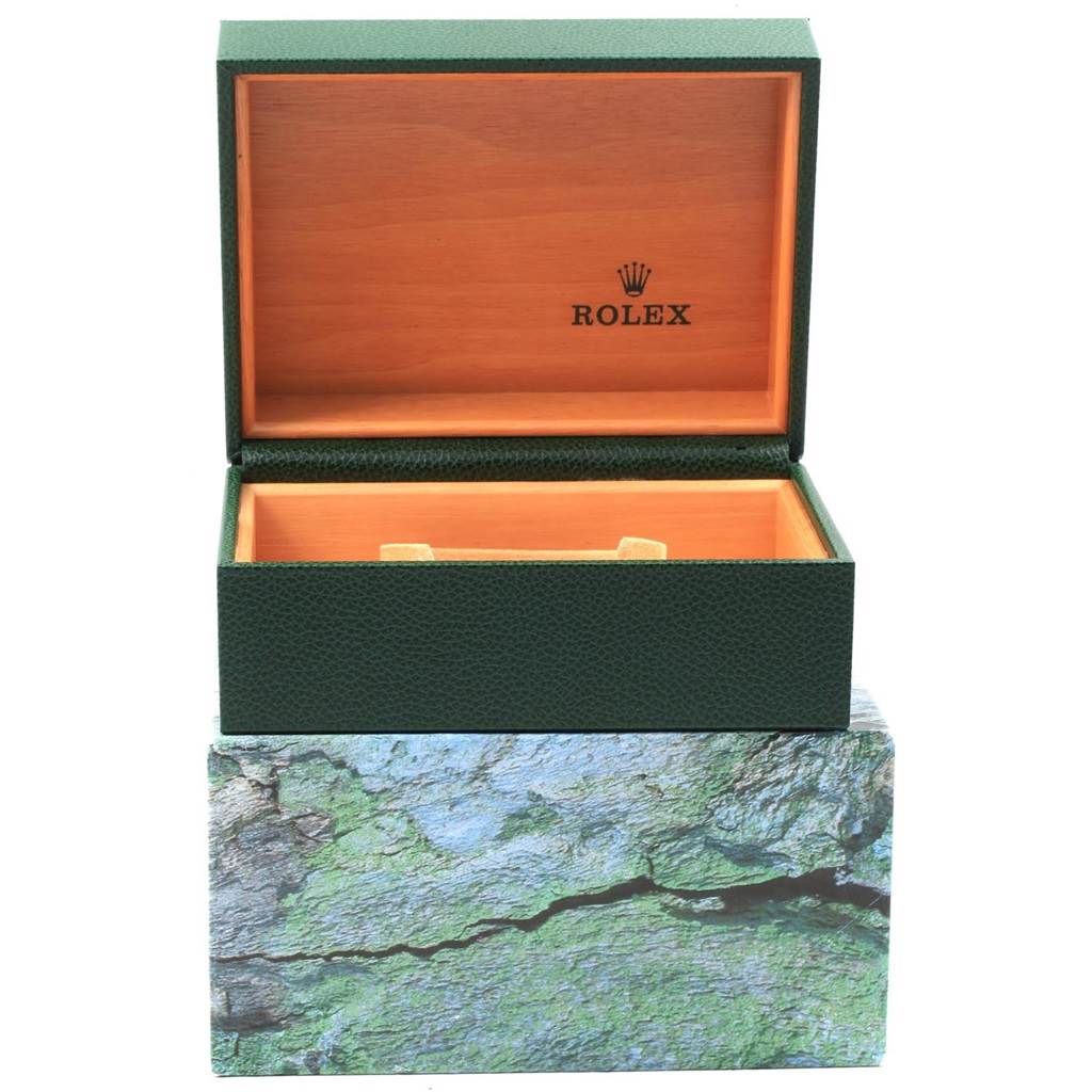 This image shows an open green Rolex Datejust 20413 Men's Steel and Gold (two tone) Champagne Dial 20413 Men's Steel and Gold (two tone) Champagne Dial watch box with a wooden interior.