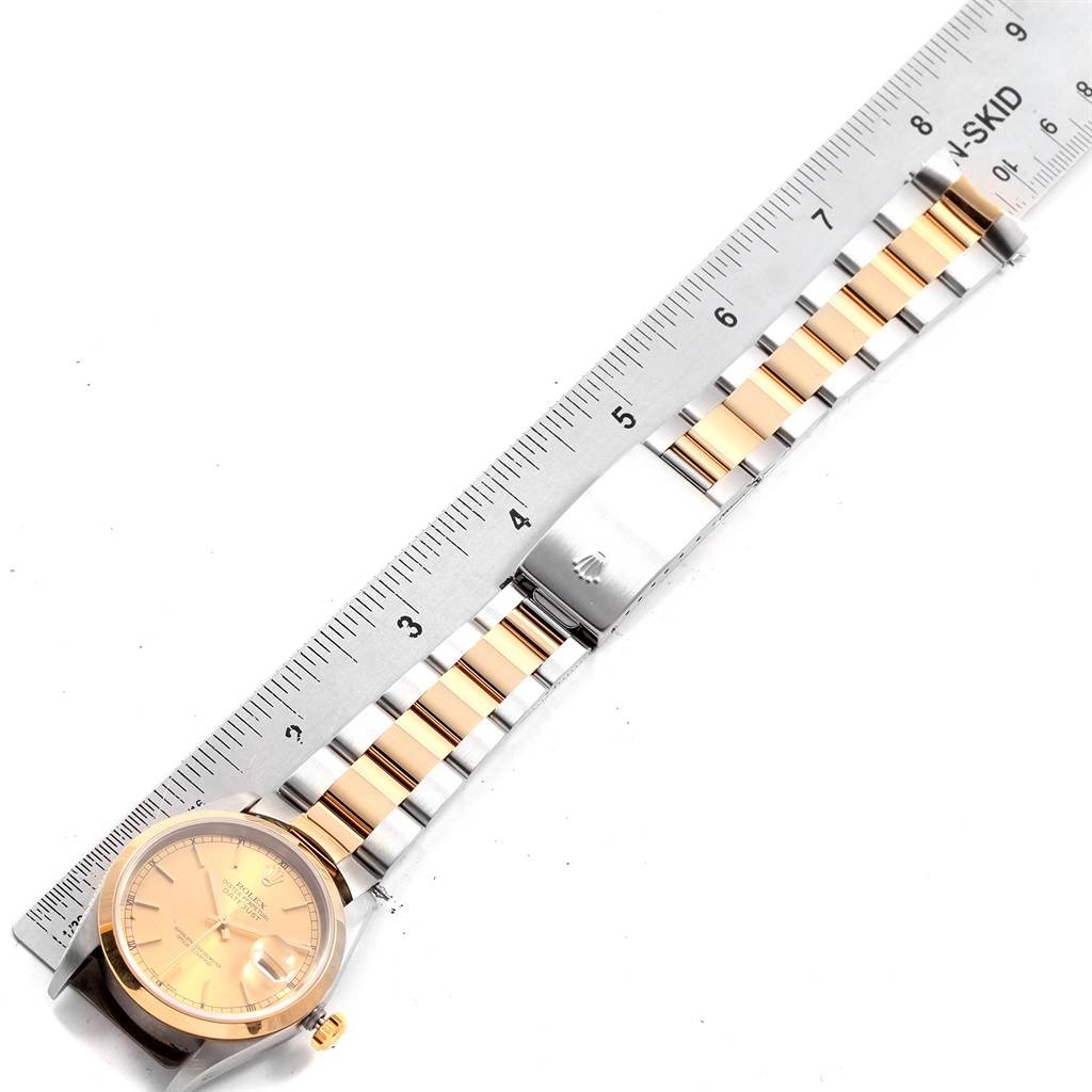 The image shows a Rolex Datejust 20413 Men's Steel and Gold (two tone) Champagne Dial 20413 Men's Steel and Gold (two tone) Champagne Dial watch laid flat, highlighting its face, bracelet, and clasp, alongside a measuring ruler.