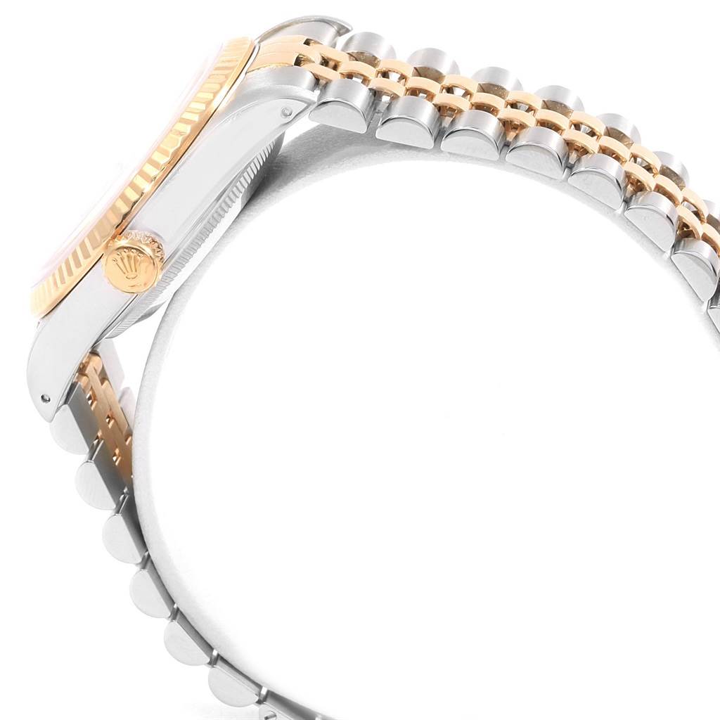 This image shows a side view of the Rolex Datejust 16233 Men
s Steel and Gold (two tone) Blue Dial 16233 Men
s Steel and Gold (two tone) Blue Dial watch, highlighting the crown and part of the bracelet.