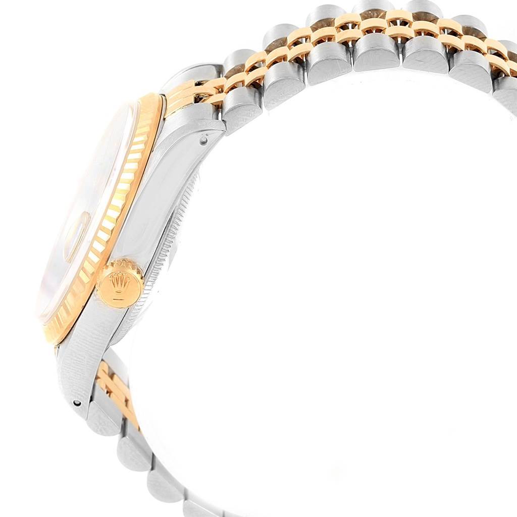 The image shows a side view of a Rolex Datejust 16233 Men
s Steel and Gold (two tone) Black Dial 16233 Men
s Steel and Gold (two tone) Black Dial watch, highlighting the bezel, crown, and part of the bracelet.