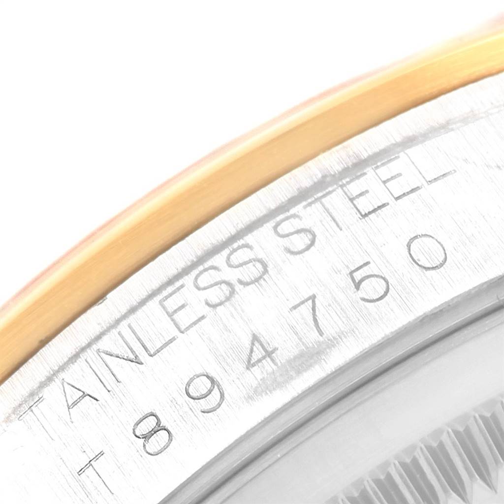 This close-up image shows the engraved serial number and part of the bezel of a Rolex Datejust 16203 Men's Steel and Gold (two tone) Grey Dial 16203 Men's Steel and Gold (two tone) Grey Dial watch.