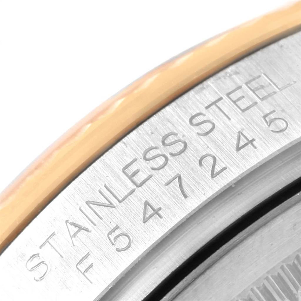 This close-up image of a Rolex Datejust 116233 Men's Steel and Gold (two tone) Champagne Dial 116233 Men's Steel and Gold (two tone) Champagne Dial watch shows the engraved edge of the stainless steel caseback.