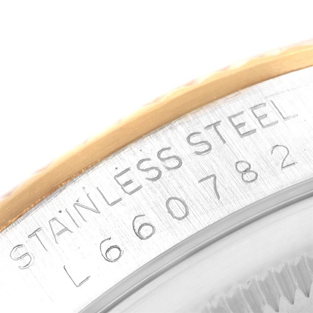 This image shows a close-up of the stainless steel case back and bezel of a Rolex Datejust 16233 Men's Steel and Gold (two tone) Champagne Dial 16233 Men's Steel and Gold (two tone) Champagne Dial watch.