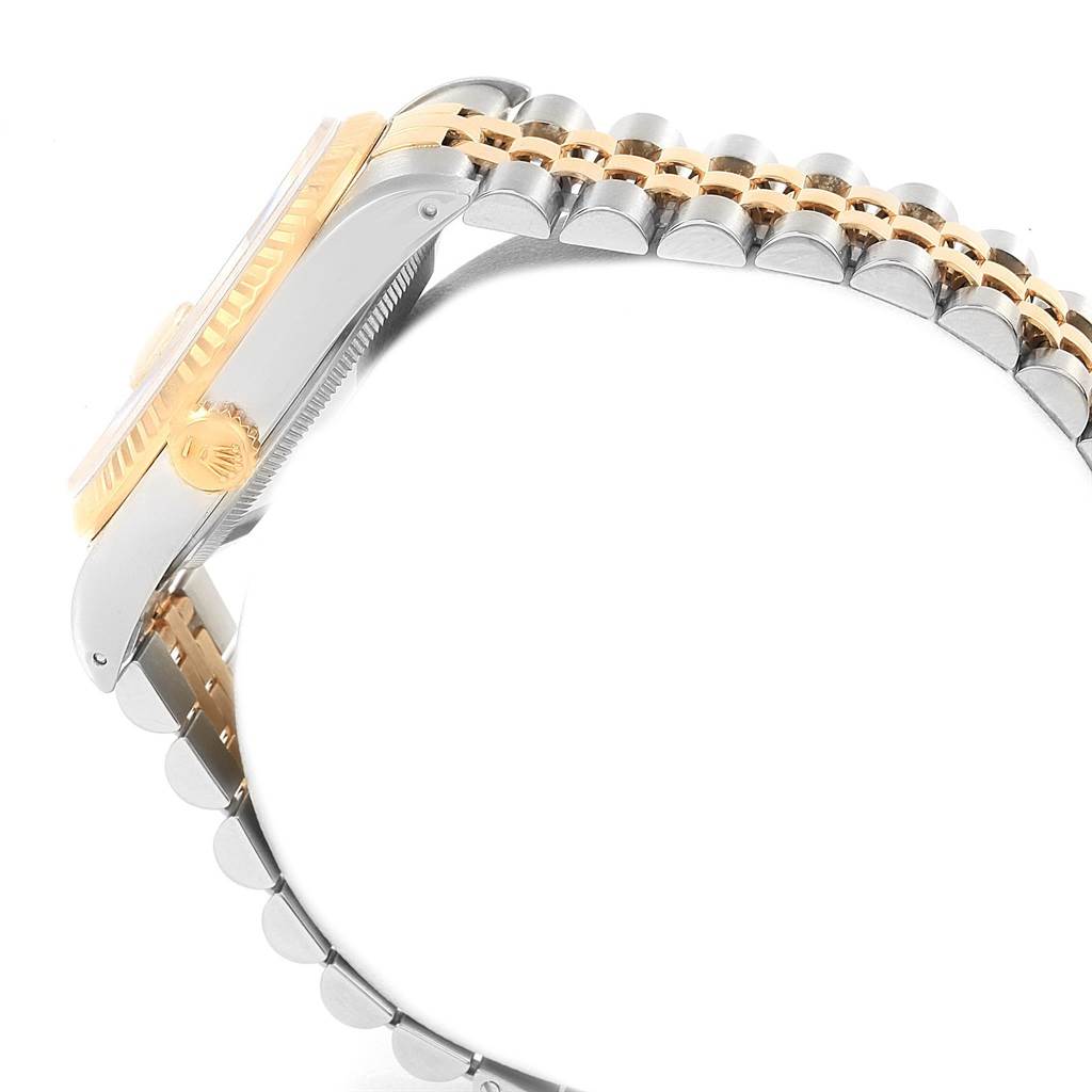 This image shows a side profile of a Rolex Datejust 16233 Men's Steel and Gold (two tone) Champagne Dial 16233 Men's Steel and Gold (two tone) Champagne Dial watch, highlighting its two-tone case, crown, and Jubilee bracelet.