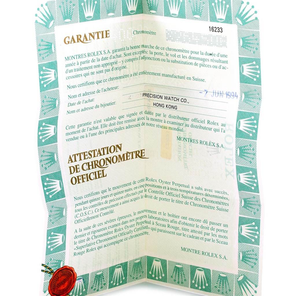 This image shows a Rolex Datejust 16233 Men's Steel and Gold (two tone) Champagne Dial 16233 Men's Steel and Gold (two tone) Champagne Dial warranty certificate from an angled top view.