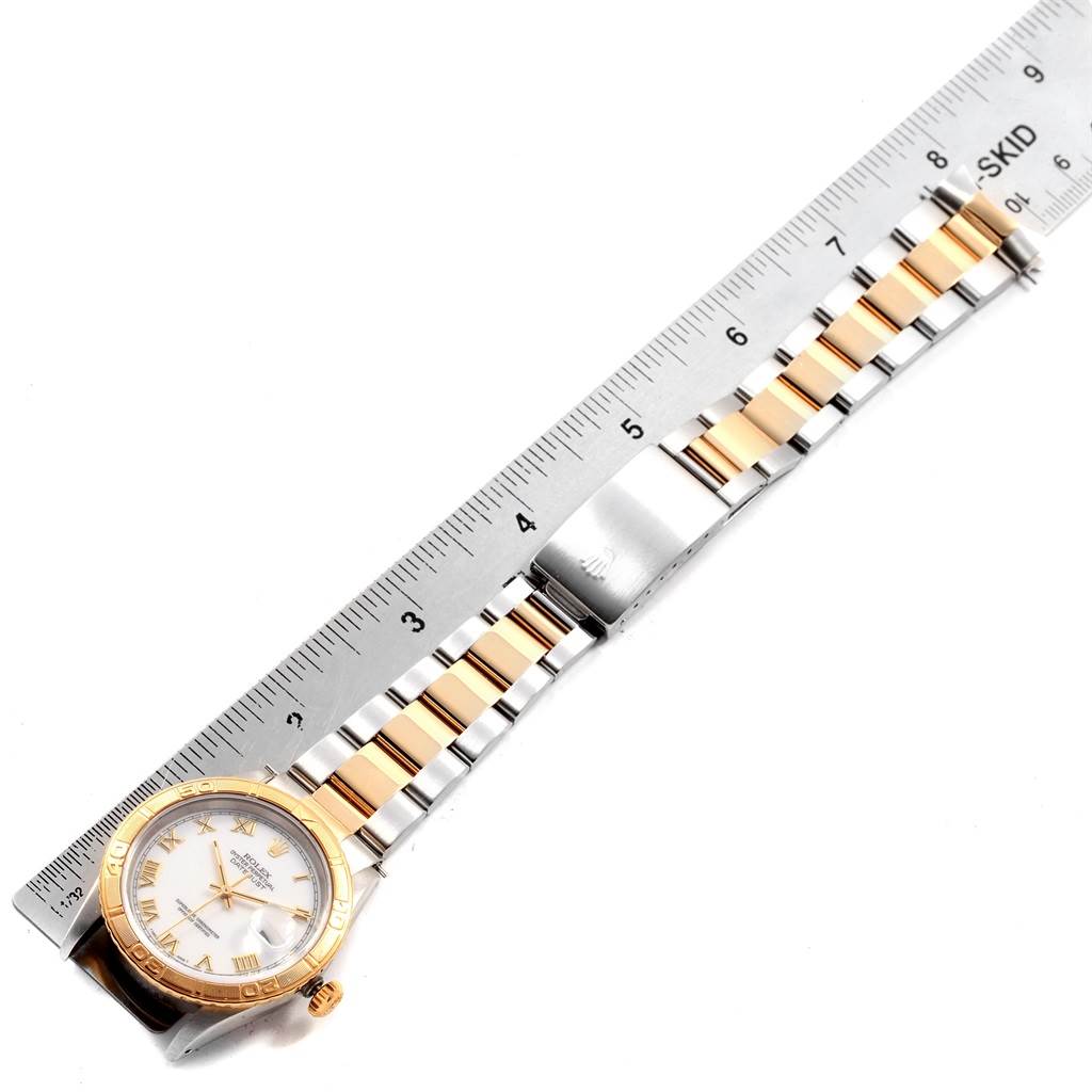 The image shows a Rolex Datejust 16263 Men
s Steel and Gold (two tone) White Dial 16263 Men
s Steel and Gold (two tone) White Dial watch in a horizontal orientation, with a ruler measuring its two-tone bracelet.
