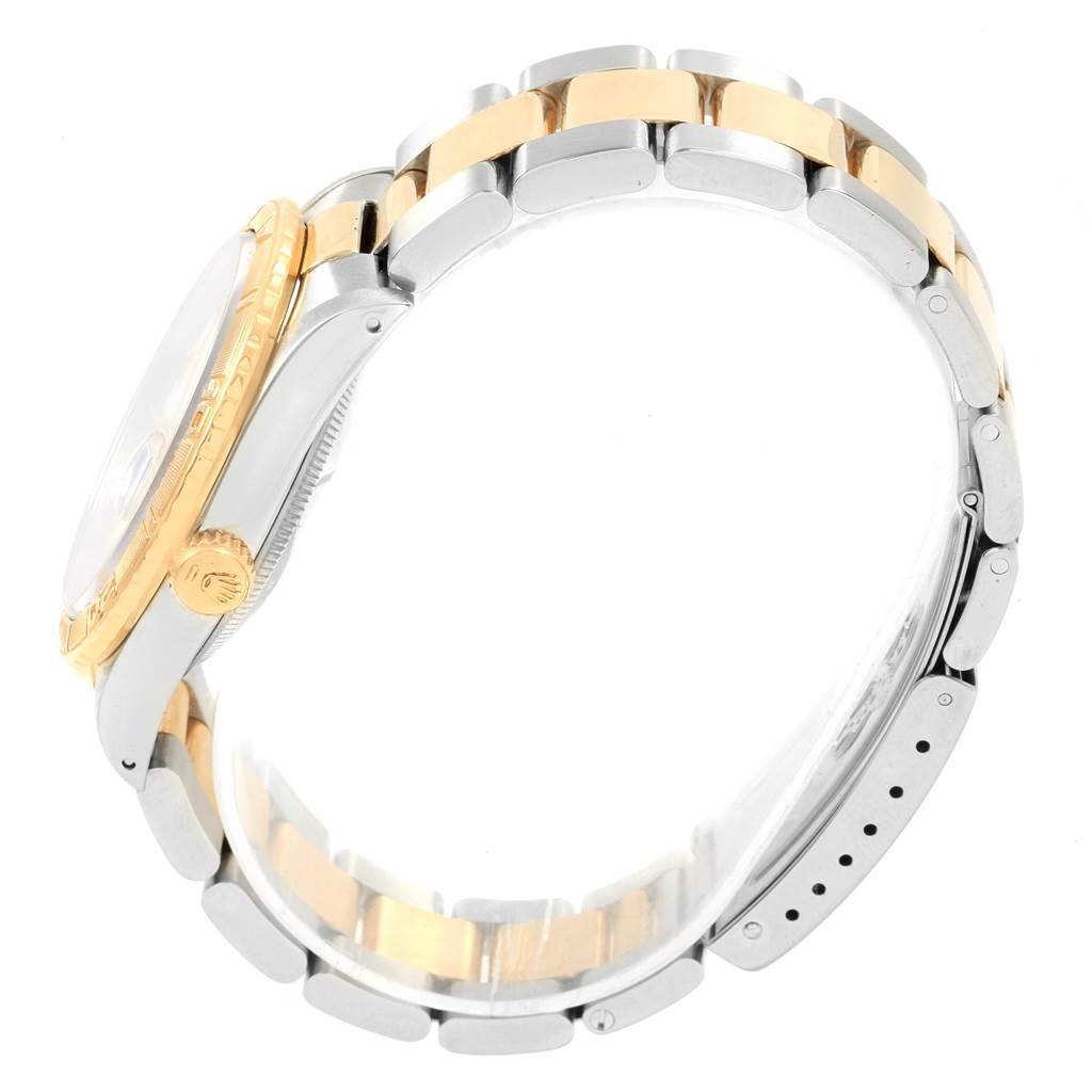 The image shows a side view of the Rolex Datejust 16263 Men
s Steel and Gold (two tone) White Dial 16263 Men
s Steel and Gold (two tone) White Dial watch with a two-tone bracelet and a partial view of the crown and bezel.