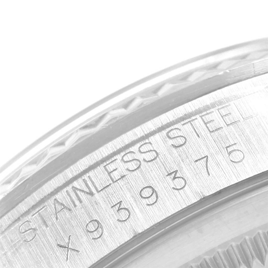 The image shows a close-up view of the engraved serial text on the stainless steel bezel of a Rolex Datejust 16234 Men
s Stainless Steel White Dial 16234 Men
s Stainless Steel White Dial watch.