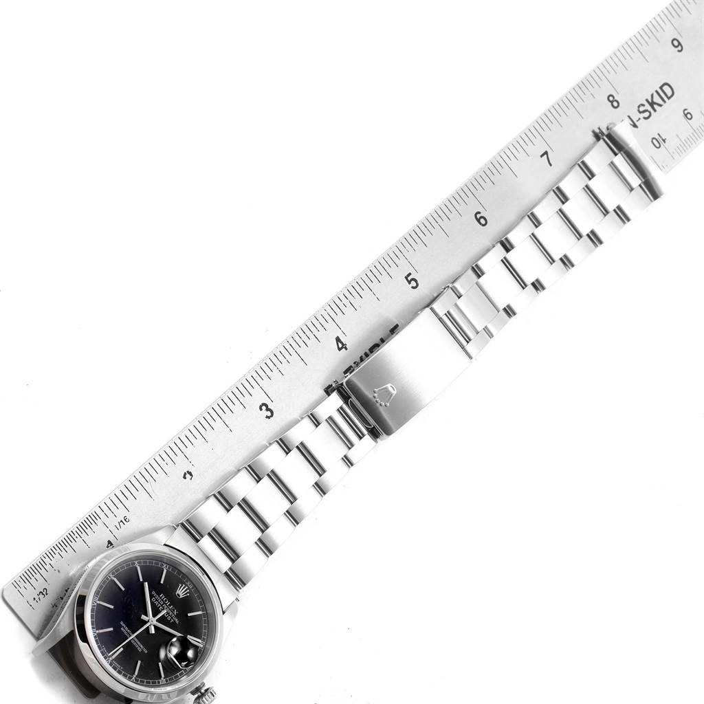 The image shows a Rolex Datejust 16200 Men's Stainless Steel Black Dial 16200 Men's Stainless Steel Black Dial watch lying flat, with a metal bracelet and part of the case, aligned next to a ruler for measurement.