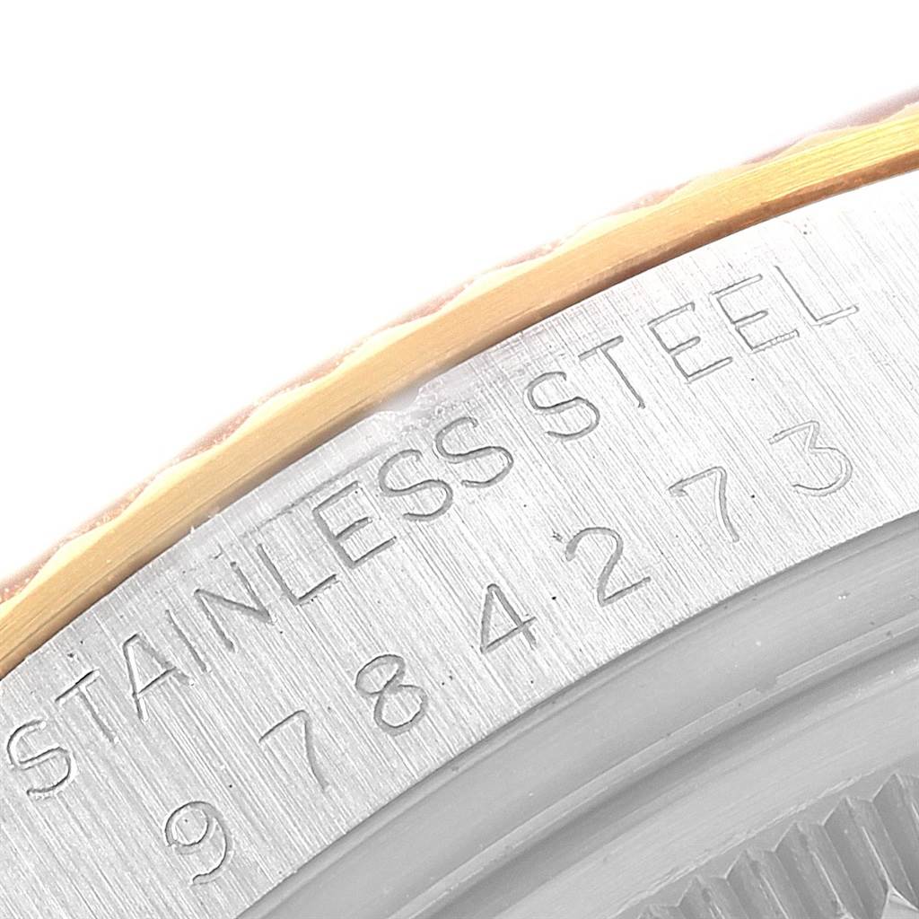 This close-up image shows the engraved serial number and "STAINLESS STEEL" marking on the case back of a Rolex Datejust 16013 Men
s Stainless Steel Champagne Dial 16013 Men
s Stainless Steel Champagne Dial watch.