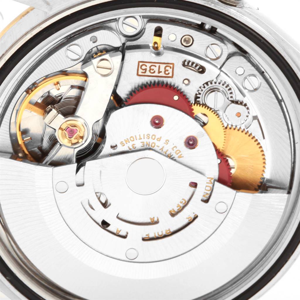 The image shows the intricate internal mechanism of a Rolex Datejust 16203 Men's Steel and Gold (two tone) Grey Dial 16203 Men's Steel and Gold (two tone) Grey Dial watch, featuring gears and the balance wheel.