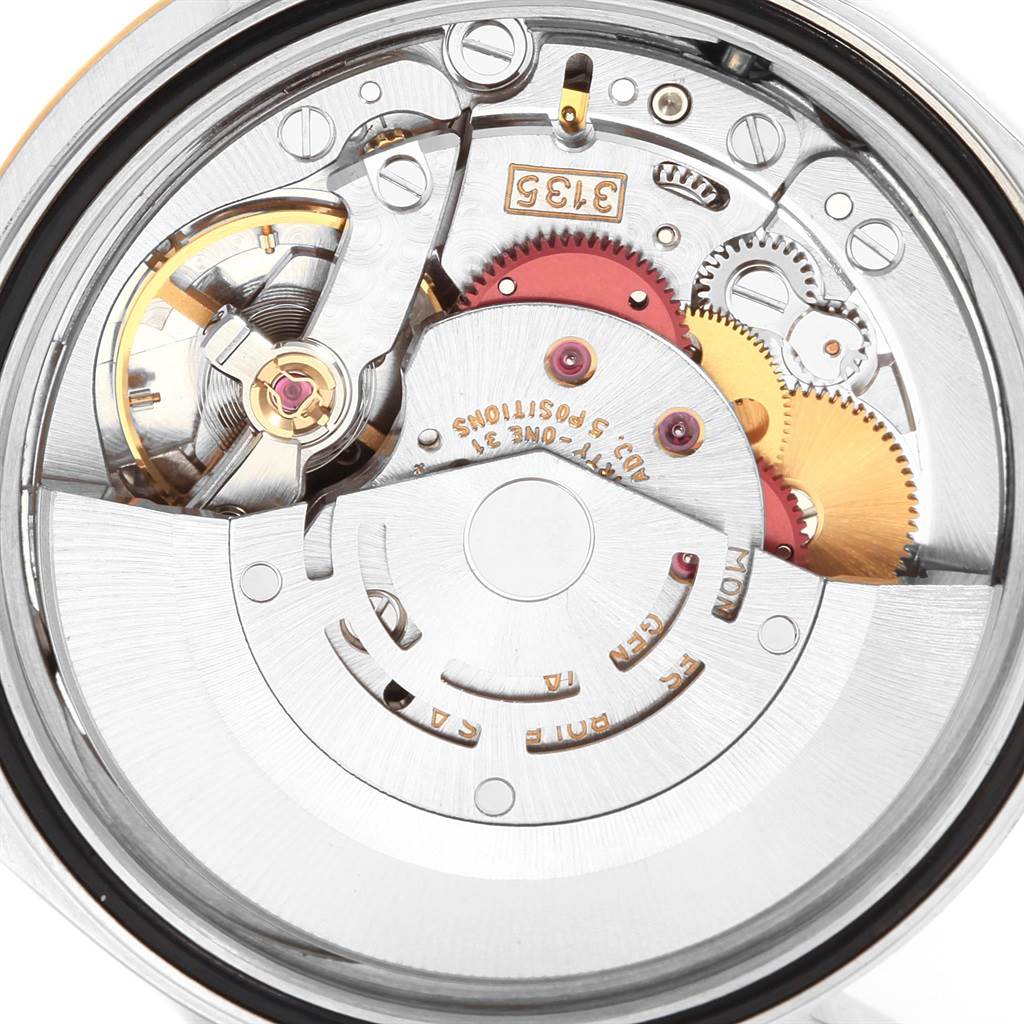 This image shows the intricate internal mechanisms and gears of a Rolex Datejust 16233 Men's Steel and Gold (two tone) Champagne Dial 16233 Men's Steel and Gold (two tone) Champagne Dial watch.