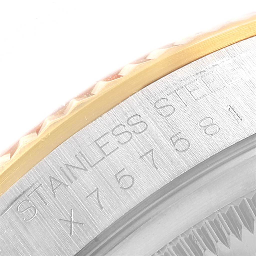This image shows a close-up of the stainless steel and gold bezel of a Rolex Datejust 16233 Men's Steel and Gold (two tone) Champagne Dial 16233 Men's Steel and Gold (two tone) Champagne Dial.
